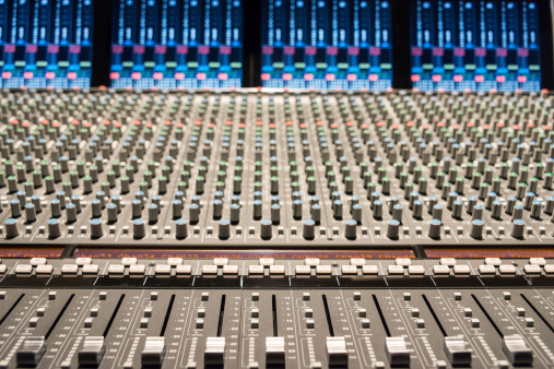 Recording studio with mixing console.