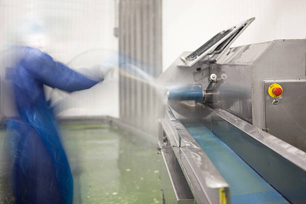 Cleaning a food processing machine stock photo