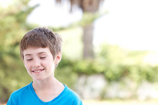 istock Smiling Boy with Blue T-shirt Looking Down 160422975