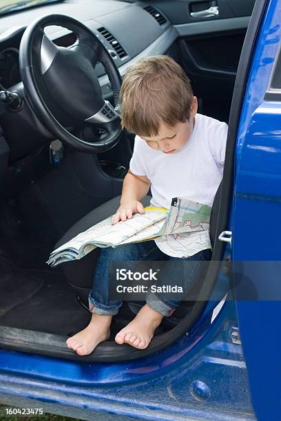 Boy With Road Map Sits In Car Stock Photo - Download Image Now - Road Map, Lost, 4-5 Years