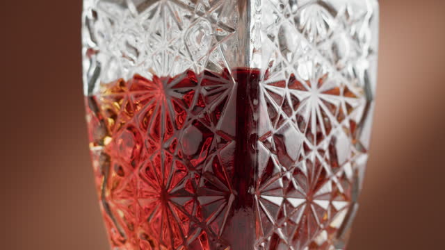 Brandy or whiskey in decanter close-up. Luxury cognac on brown background. Alcohol amber drink, drinking rum, liqour beverage in glass.