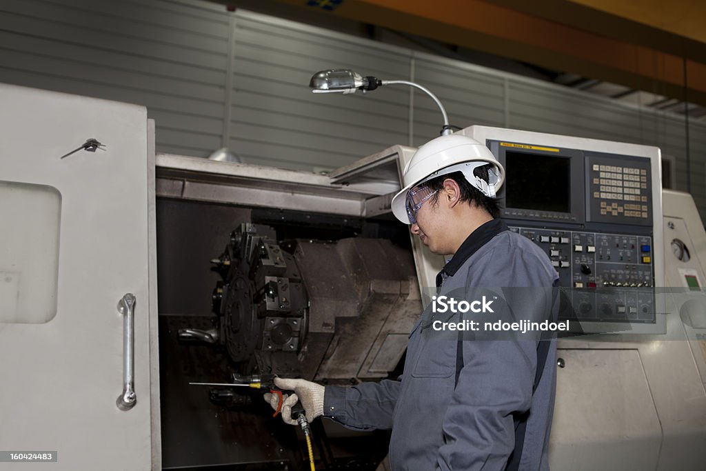 mechanical technician of cnc machine mechanical technician operative of cnc machine Machinery Stock Photo