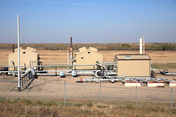 Exterior Of Oil And Gas Industry Compressosr Station Working in harmony with agriculture the transmission of gas from the field enters here to be disbursed. compressor photos stock pictures, royalty-free photos & images