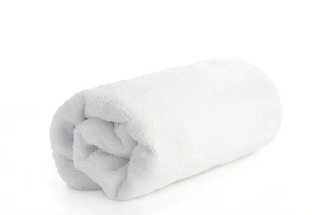 rolled up white beach towel on  white background