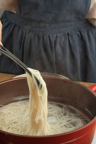 istock Female Hand Cooking Somen or Somyeon 1604281601