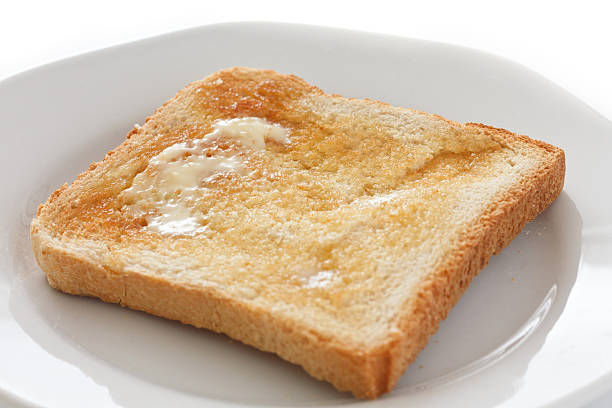 istock Slice of white buttered toast on a plate 160429139