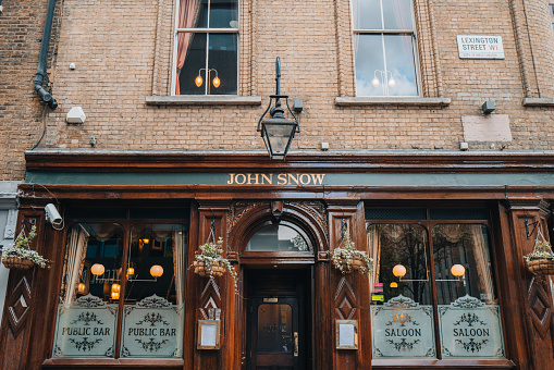 London, UK - April 13, 2023: Facade and entrance of John Snow, a dark-wood saloon bar in London serving Yorkshire ales, named after doctor who traced London cholera outbreak.