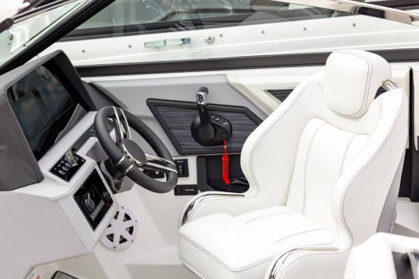 istock Steering wheel and control panel on luxury motor boat background with copy space 1604321424
