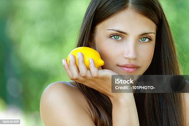 Young Woman With Yellow Lemon Stock Photo - Download Image Now - Adult, Beautiful People, Beauty