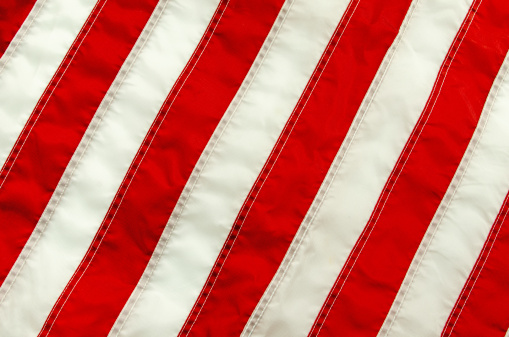 An American flag close-up with only the stripes.