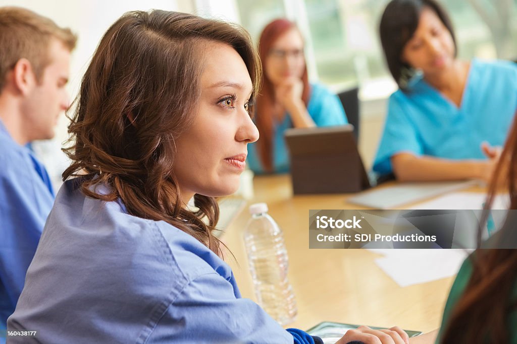 Serious nursing or medical students discussing patient in meeting Education Stock Photo