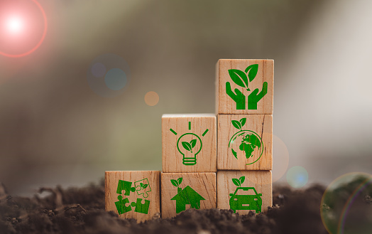 Sustainable development and green business from renewable energy CO2 emission reduction concept, the green icon on natural background wood block