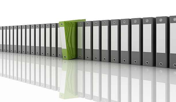 A row of gray folders with a lone green folder sticking out stock photo