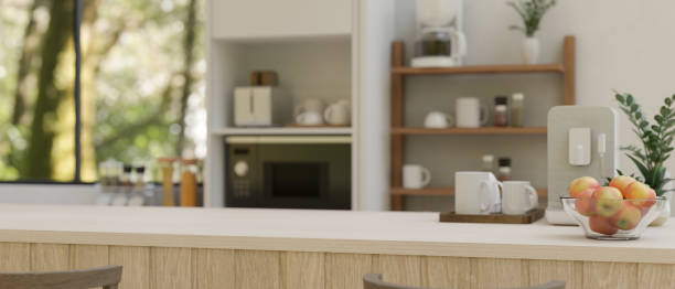 istock Copy space on a minimal white kitchen countertop with coffee maker in a modern white kitchen 1604464665