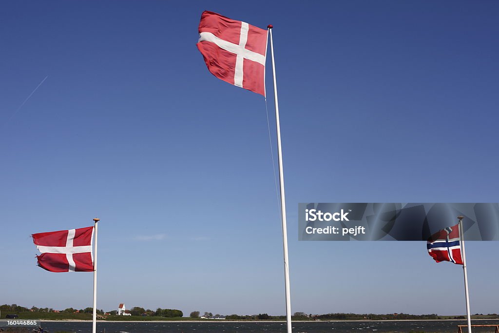 Flags of Denmark and Norway in Limfjorden Flags of Denmark and Norway in Limfjorden with the island Jegind Denmark Stock Photo