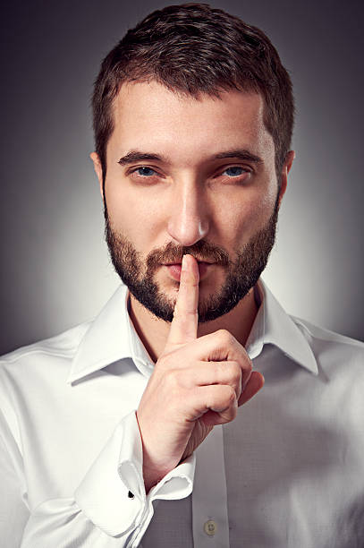 istock serious man showing silent sign 160446950