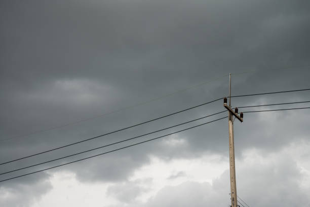 istock Torrential rain dark clouds is coming with electricity post. 1604519329