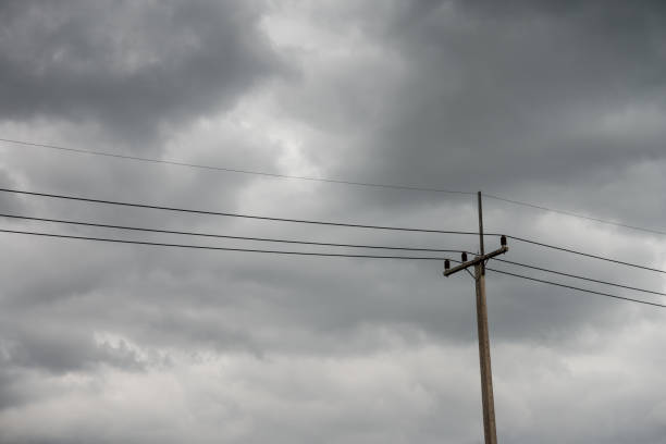 istock Torrential rain dark clouds is coming with electricity post. 1604519511