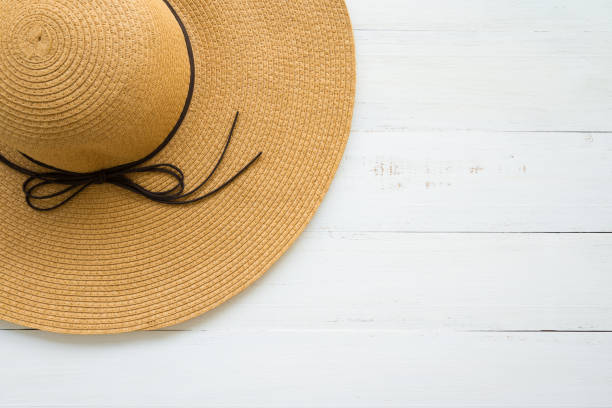 istock Large brown lady hat on white wooden background. 1604538376