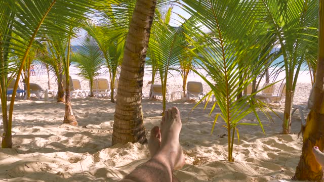 Male feet on sandy ocean beach. Weekend travel