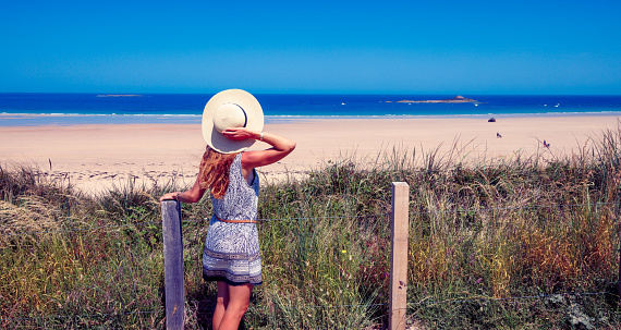 Woman tourist looking and beautiful beach and atlantic ocean- Brittany in France