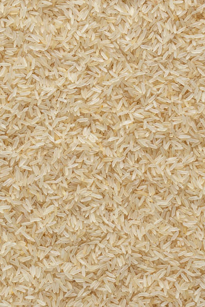 istock Handful of rice on a white background. 1604676129