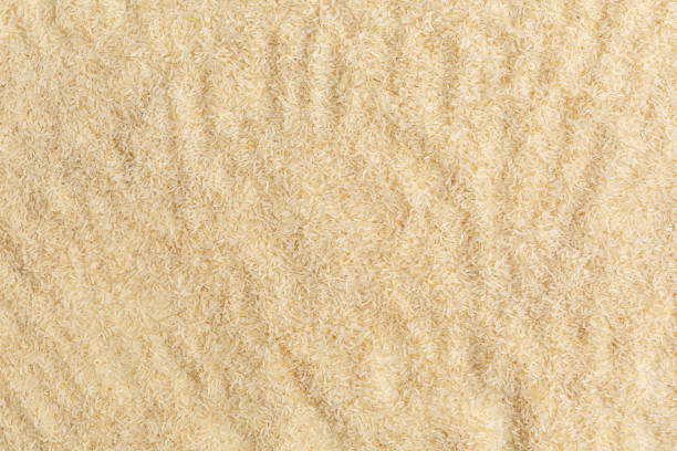 istock Handful of rice on a white background. 1604676403