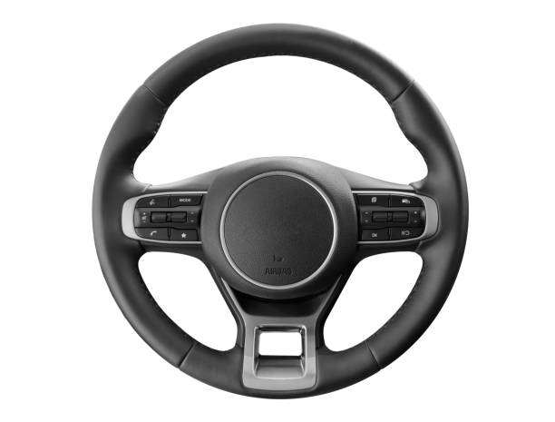 istock Modern car interior. Steering wheel with media phone control buttons isolated on white background. Car interior details. Steering wheel isolated on white background 1604676521