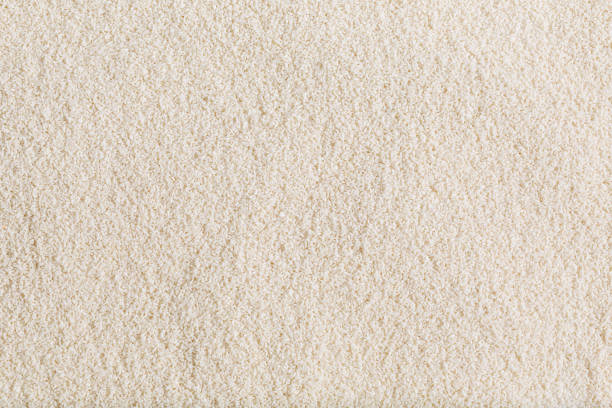 istock Handful of rice on a white background. 1604677077