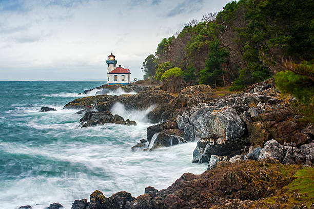 Lime Kiln Lighthouse The Lime Kiln Lighthouse is located on San Juan Island over looking the Haro Strait near Friday Harbor, Washington, USA. puget sound stock pictures, royalty-free photos & images