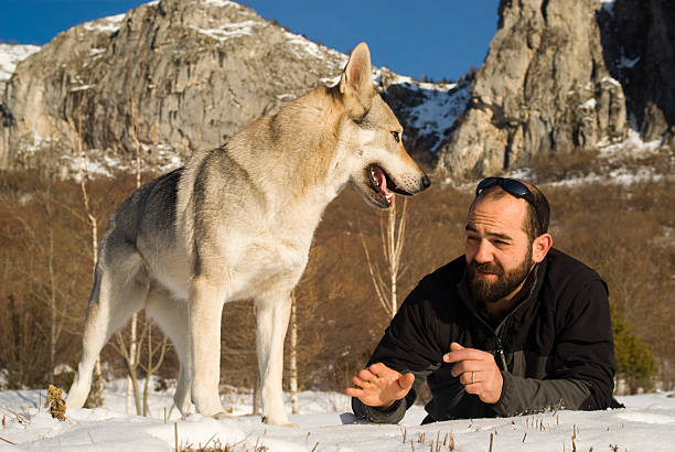 istock Man with dog in winter forest 160469997