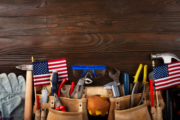 istock Labor day banner mockup of tools toolbelt and us flag on wooden background 1604705708