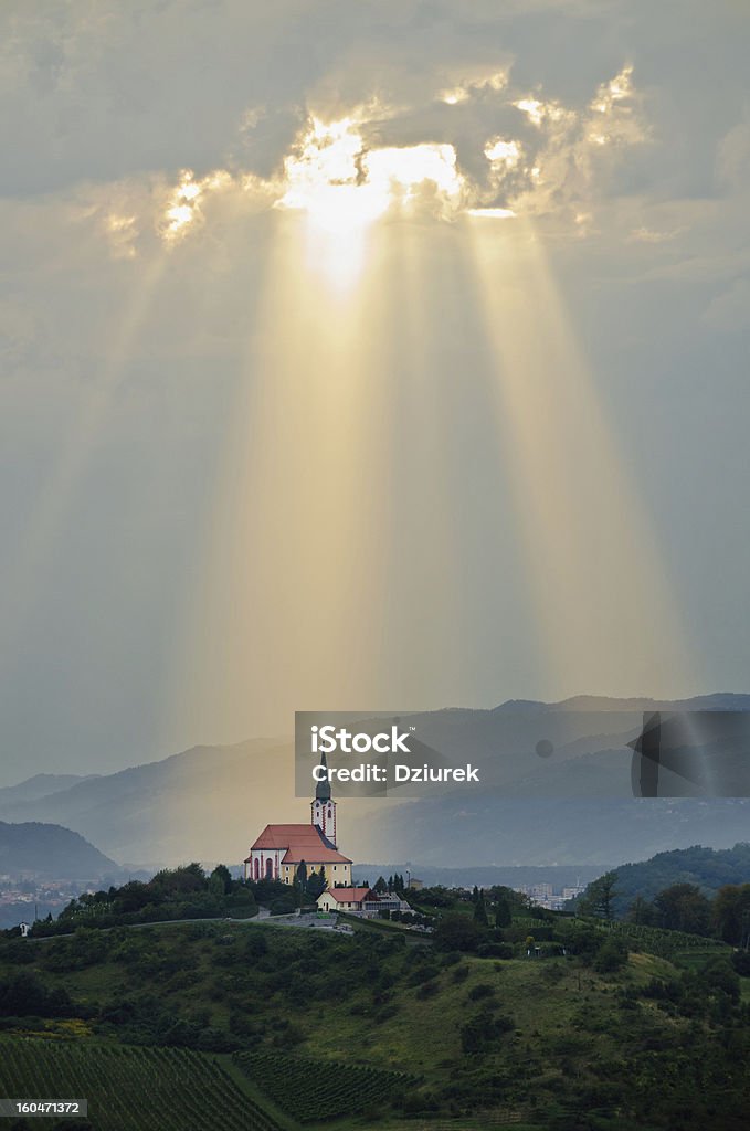 A miracle occurring whilst sun rays gleam down Sun rays shining down on a Church Built Structure Stock Photo