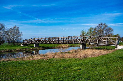 A view of the wooden bridge over the river Unstrut in Schönfeld near Artern in Germany