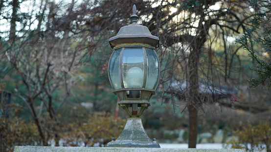 Old antique light on street wall outdoors in winter