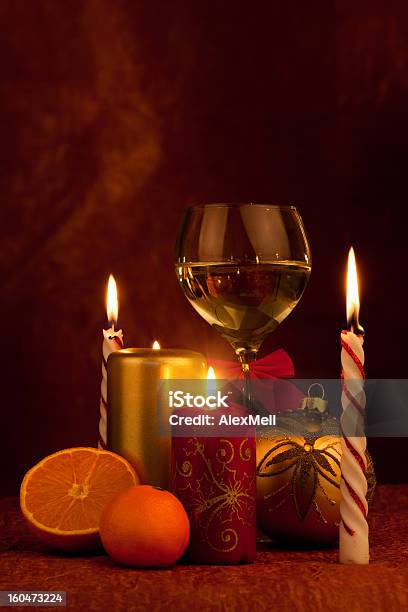 Glas With Champagne And Burning Candles New Year Ball Stock Photo - Download Image Now