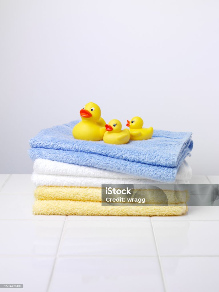 Three Little Ducks on Towels Mother duck with two baby ducks, on a pile of towels, in a bathroom, with copy space. Baby - Human Age Stock Photo