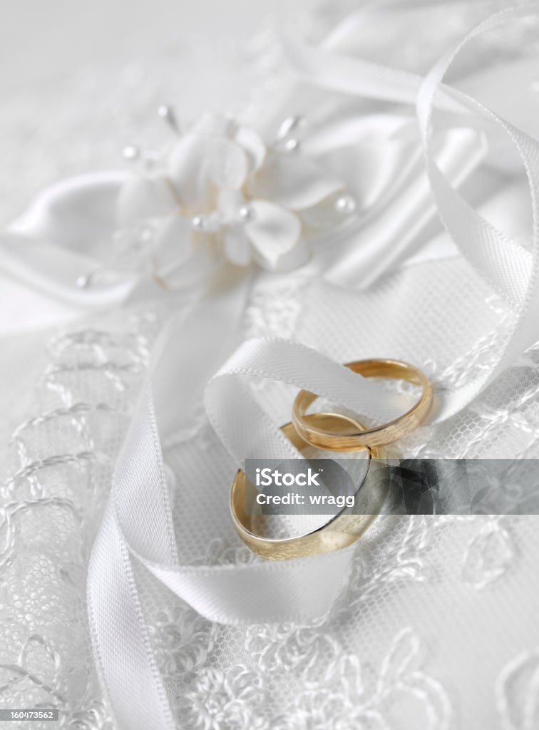 Entwined wedding Rings Gold wedding rings together on a lace ring cushion. Celebration Event Stock Photo