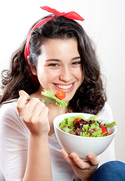 istock Happy girl eating salad 160474302