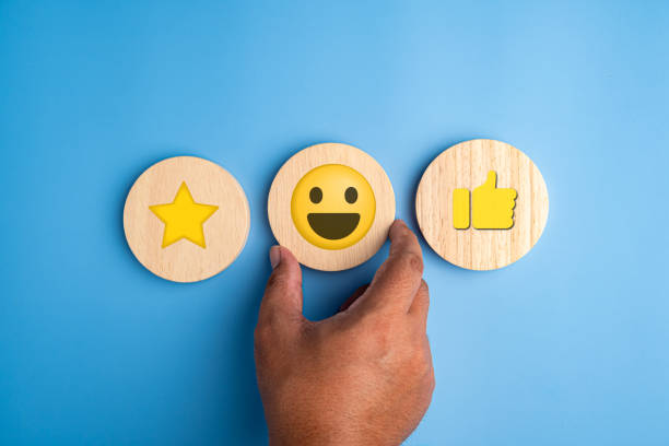 istock Customer putting wood sphere smiley face emoticon. Service rating, feedback, interesting, satisfaction concept 1604743575