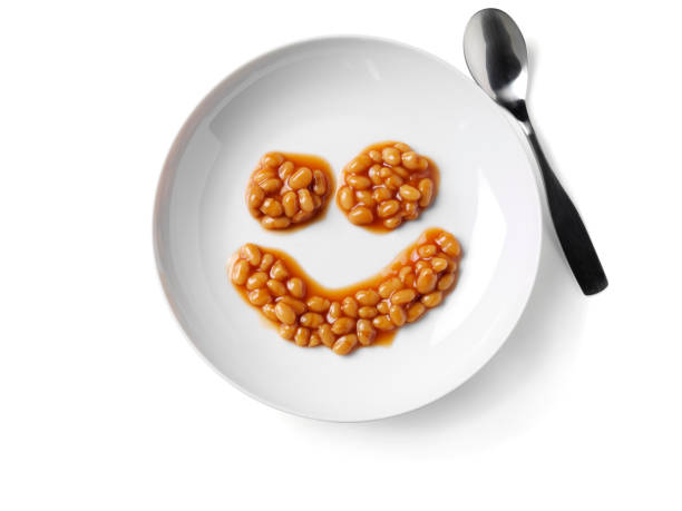 Smily Face Baked Beans Smiley face baked beans, isolated on white with clipping path. baked beans stock pictures, royalty-free photos & images