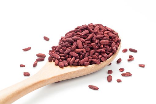 Red yeast rice in a wooden spoon. Chinese traditional food and medicine.