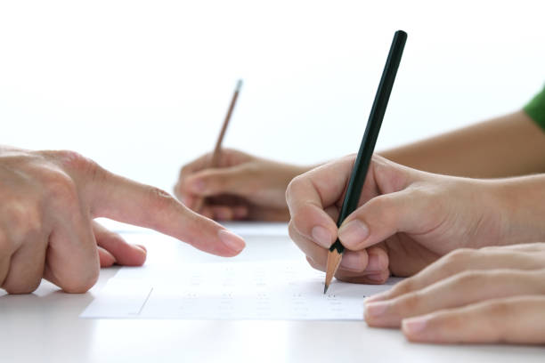 istock Children's hands studying in classroom with teacher 1604755007