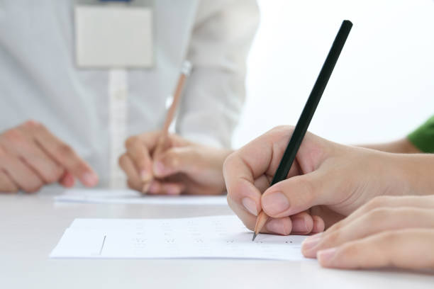 istock Children's hands studying in classroom with teacher 1604755547