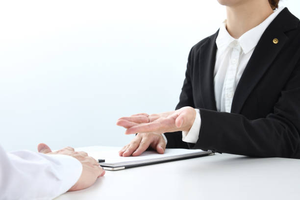 istock Japanese female lawyer talking with client 1604756072