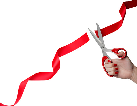 Cutting a red ribbon. isolated on white with clipping path