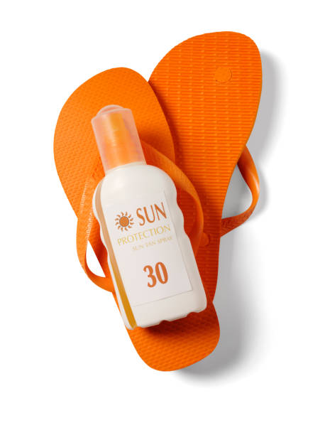 A small starfish, a tube of sunscreen and the sun painted on the sand. A preparation to protect the skin from sunlight.