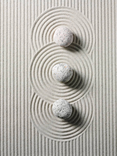 Three Zen Stones and Circles Three zen stones and circles in sand. Overhead view tranquil scene photos stock pictures, royalty-free photos & images