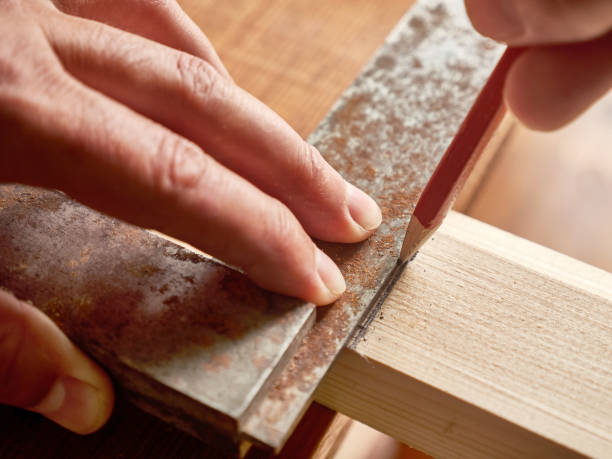 With the help of a handkerchief, a wooden board is marked. Carpentry works. A tool for marking wooden blanks. With the help of a handkerchief, a wooden board is marked. Carpentry works. A tool for marking wooden blanks. miter saw stock pictures, royalty-free photos & images