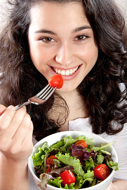 istock Happy girl eating salad 160476627